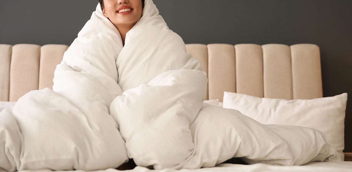 A thick comforter on a bed, the kind the mammoth washers are built for